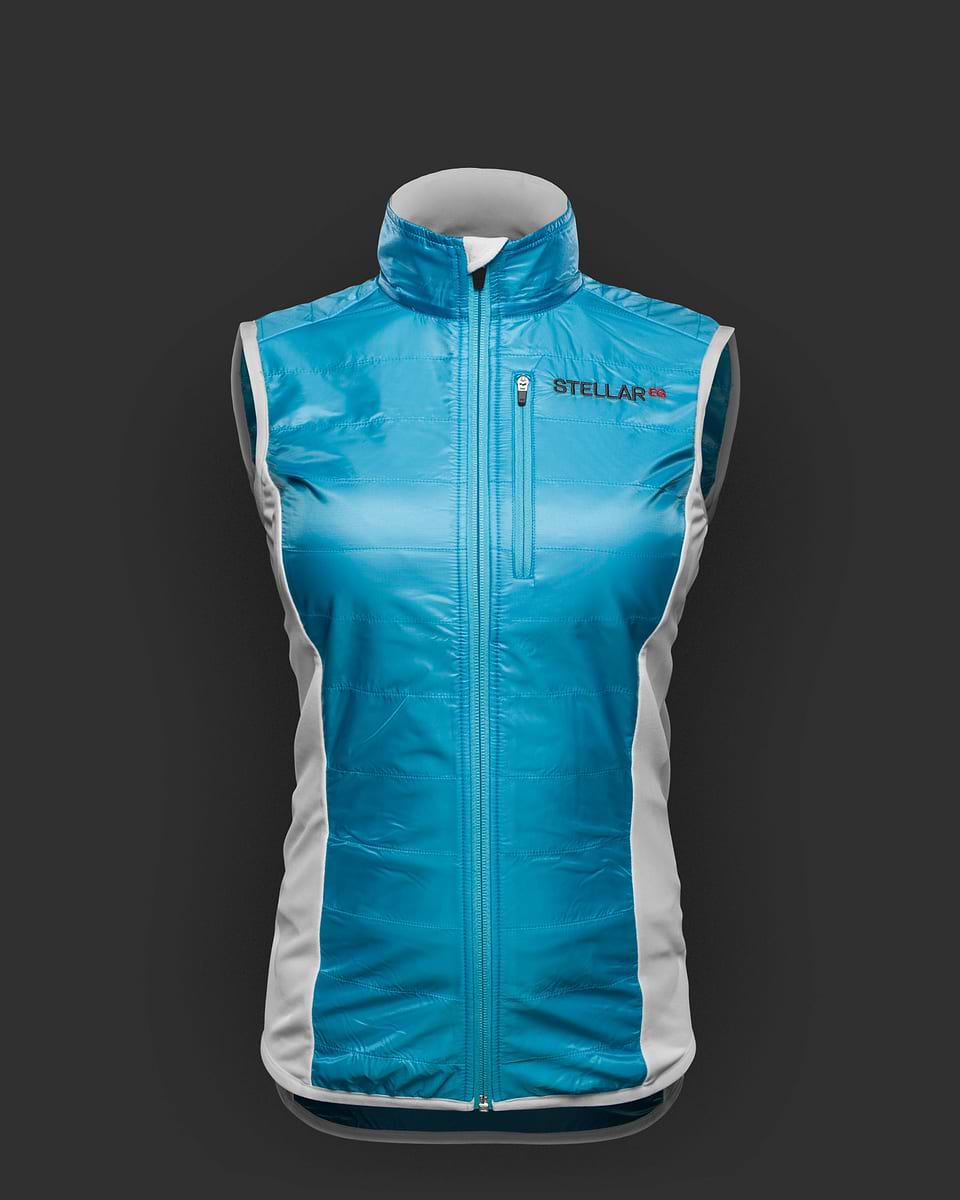 Blue and white hybrid wind vest for women. Stellar Equipment. The Hybrid Vest combines a windproof ultralight shell material with super stretchy Fieldsensor™ lightweight fleece fabric.