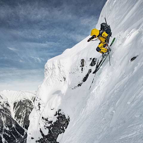 Tanner Elliott skiing down a steep face in Terrace, Canada. He is both exploring his and his gears limit. Wearing the full Stellar Equipment Guided Shell 2.0 System in Yellow. Photo taken by Mattias Fredriksson.