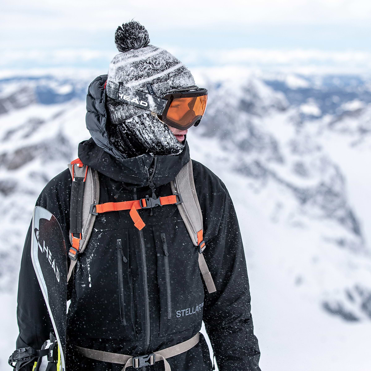 Cody Bramwell standing on a summit in Engelberg, Switzerland. Wearing the Stellar EQ Free Shell Jacket in Black.