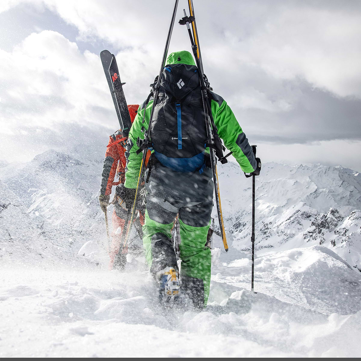Baptiste Sjöström climbing a ridge in Verbier, Switzerland. He is wearing the full Stellar Equipment mens Guide Shell 2.0 System in yellow.