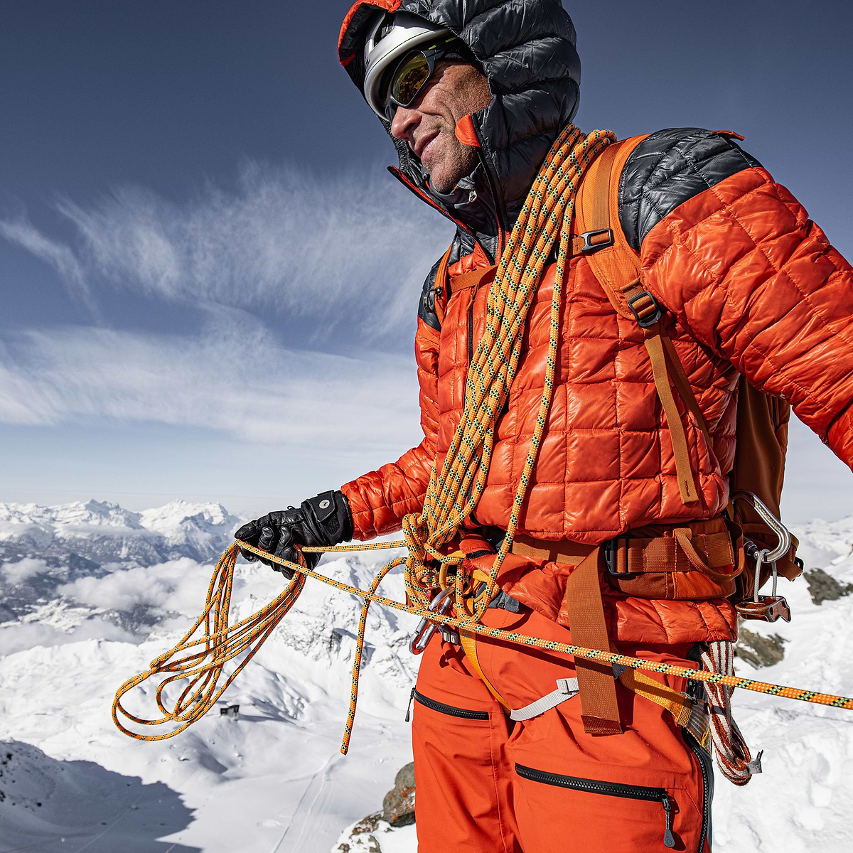 Mountain guide Jonas Swensson just finished an ascent in Verbier, Switzerland. Wearing the Stellar Equipment Mens Hyperlight Down Hood in Orange.