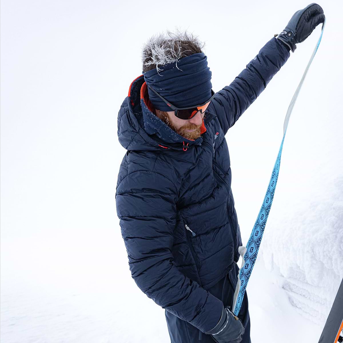 David Kantermo removing his skins and getting ready to ski in Duved, Sweden. Wearing the Stelar EQ Ultralight Down Hood in dark blue.