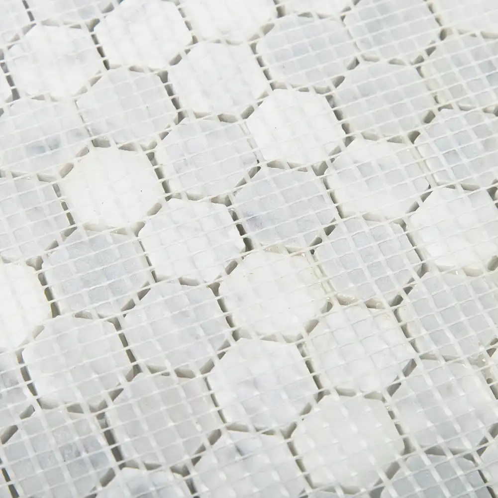 Close up view of mesh fabric on back of 1x1 Marble Honed Hexagon Mosaic Tile