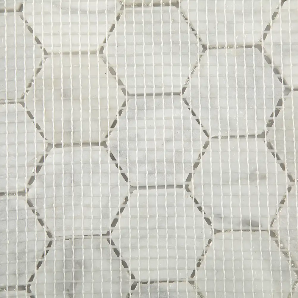 Close up view of mesh fabric on back of 2x2 Marble Honed Hexagon Mosaic Tile