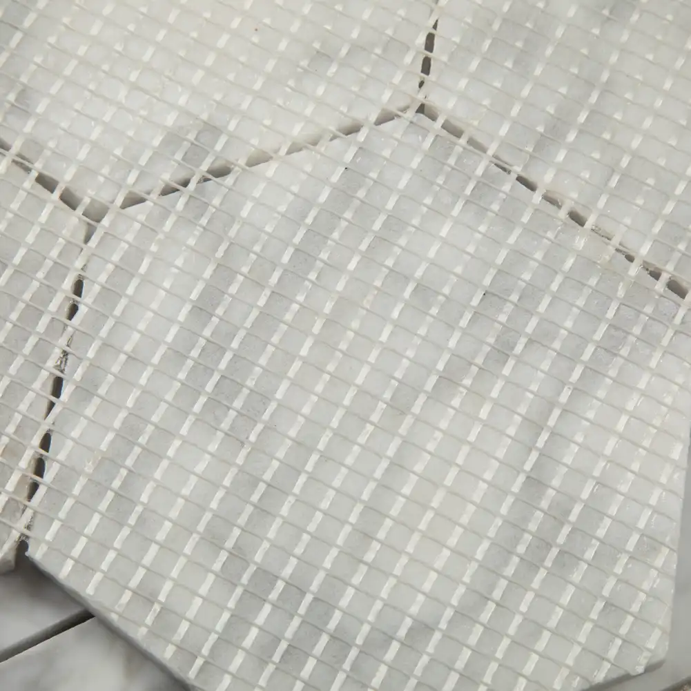 Close up view of mesh fabric on back of 5x5 Marble Honed Hexagon Mosaic Tile