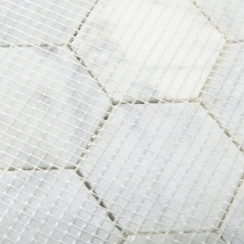 Close up view of mesh fabric on back of 3x3 Marble Polished Hexagon Mosaic Tile