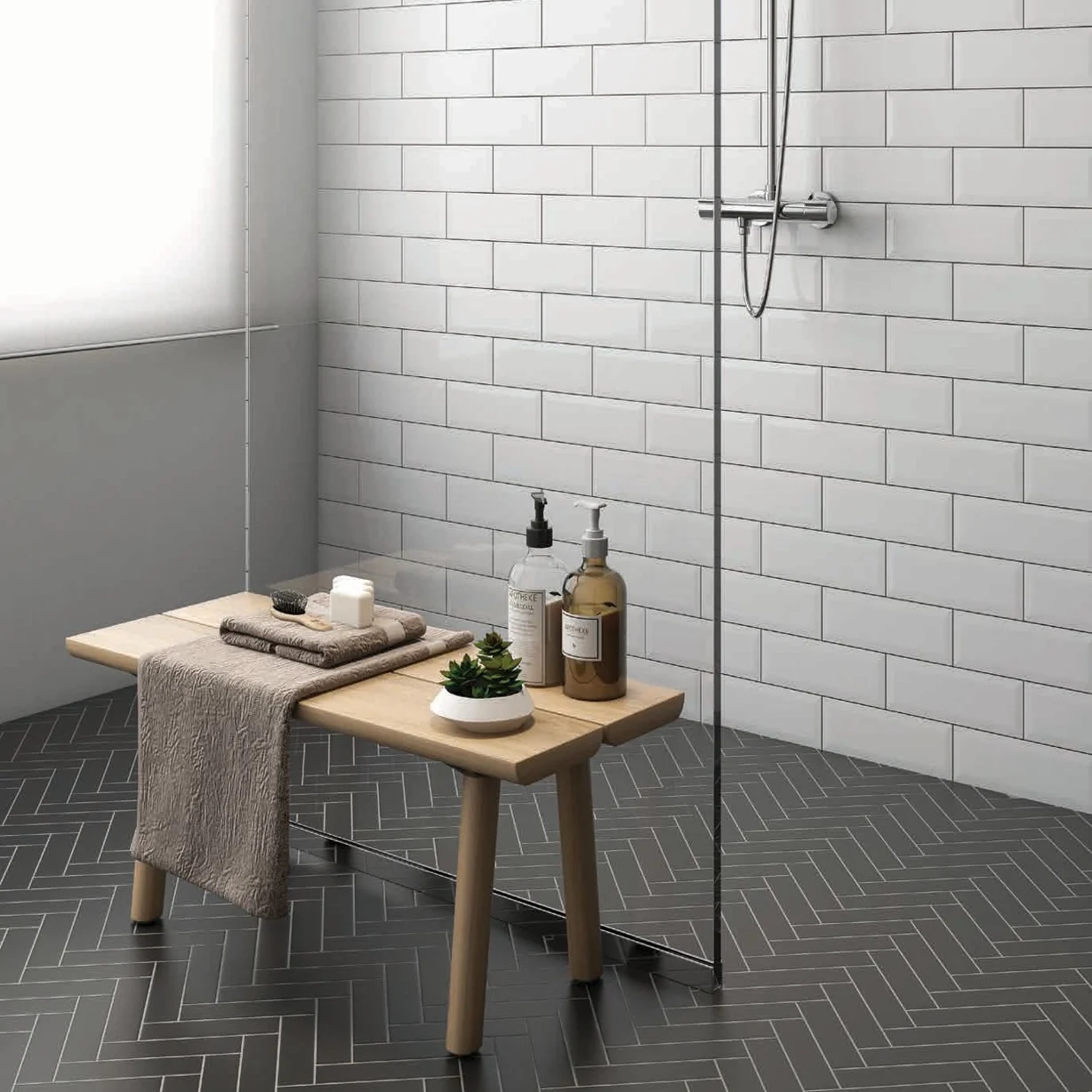 Installation of 2x8 Herringbone Mosaic Tile in Black Matte Color in Shower Floor